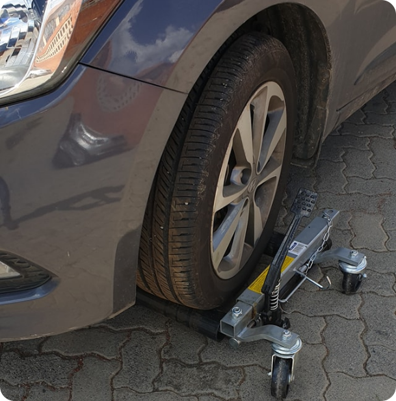 dolly wheels under the vehicle's front wheel for support.